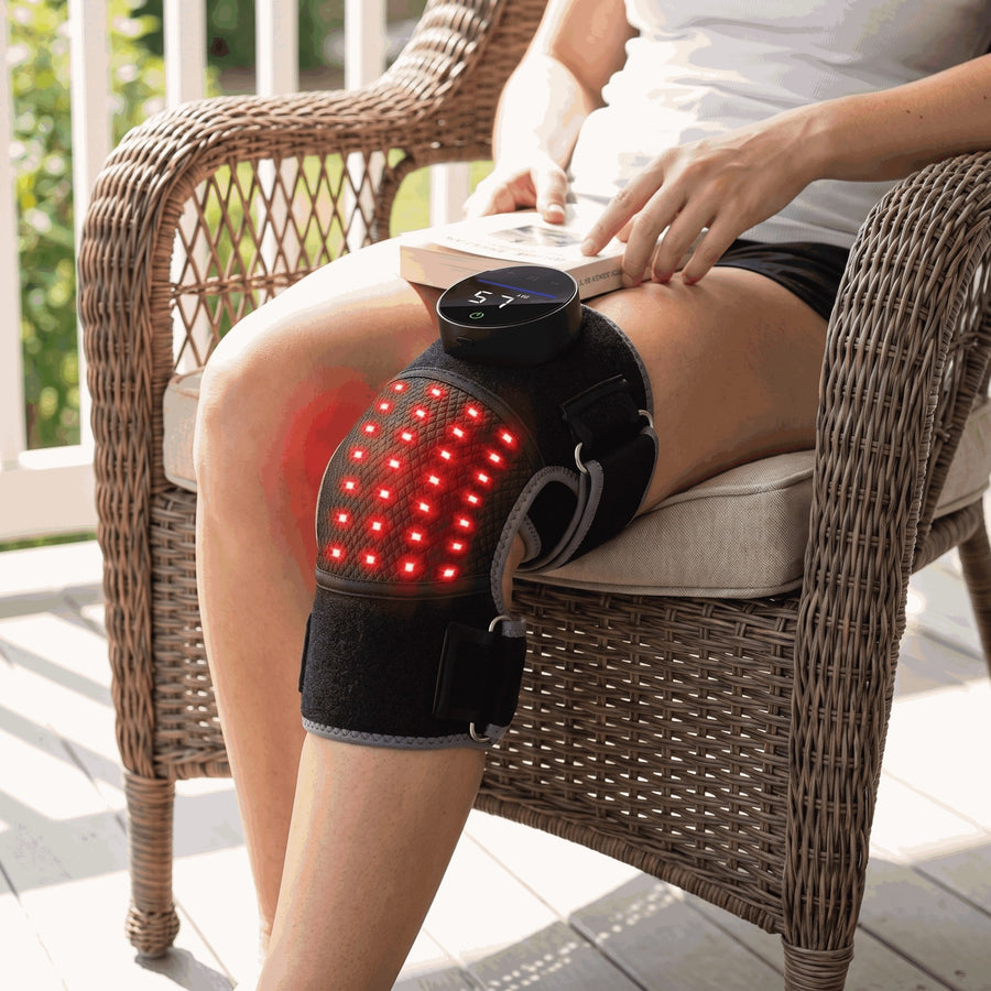 Woman reading on a porch chair wearing the cordless Bellrose knee wrap
